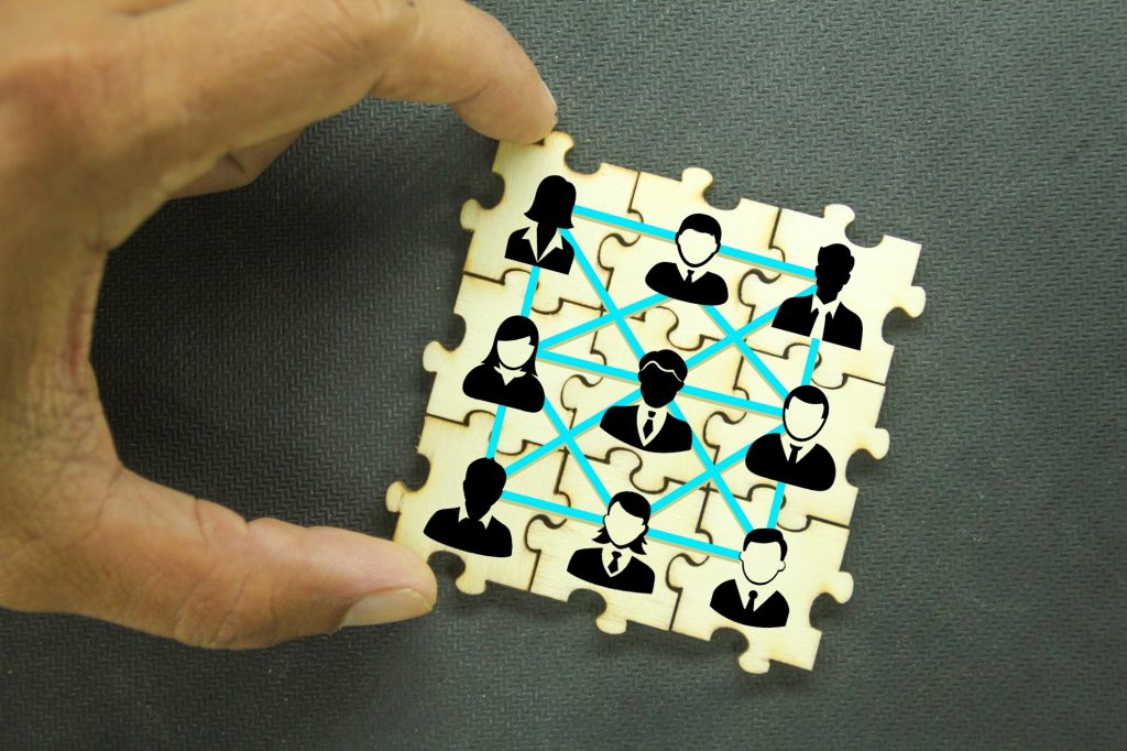 Puzzles with icons of a group of team workers. the concept of group relationships